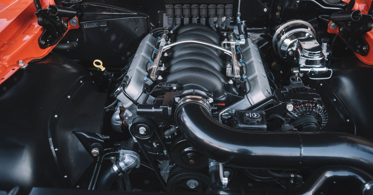A powerful sports car engine with intricate components. Everything is in pristine condition and shiny.