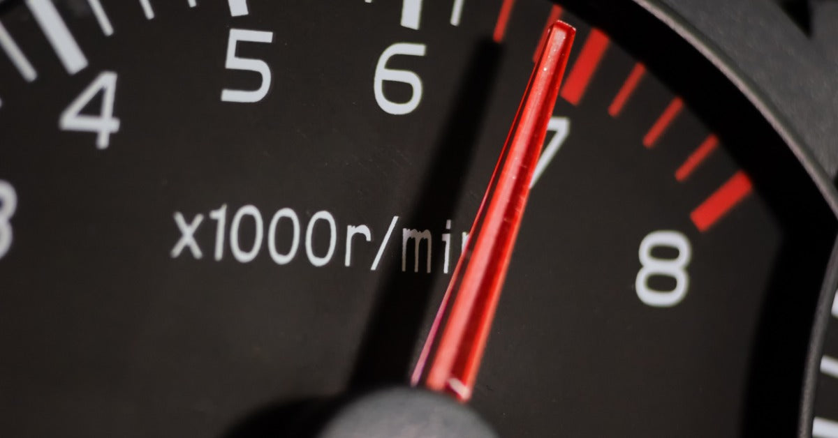 A close-up of a vehicle's tachometer showing numbered markings and a needle indicating the engine speed.